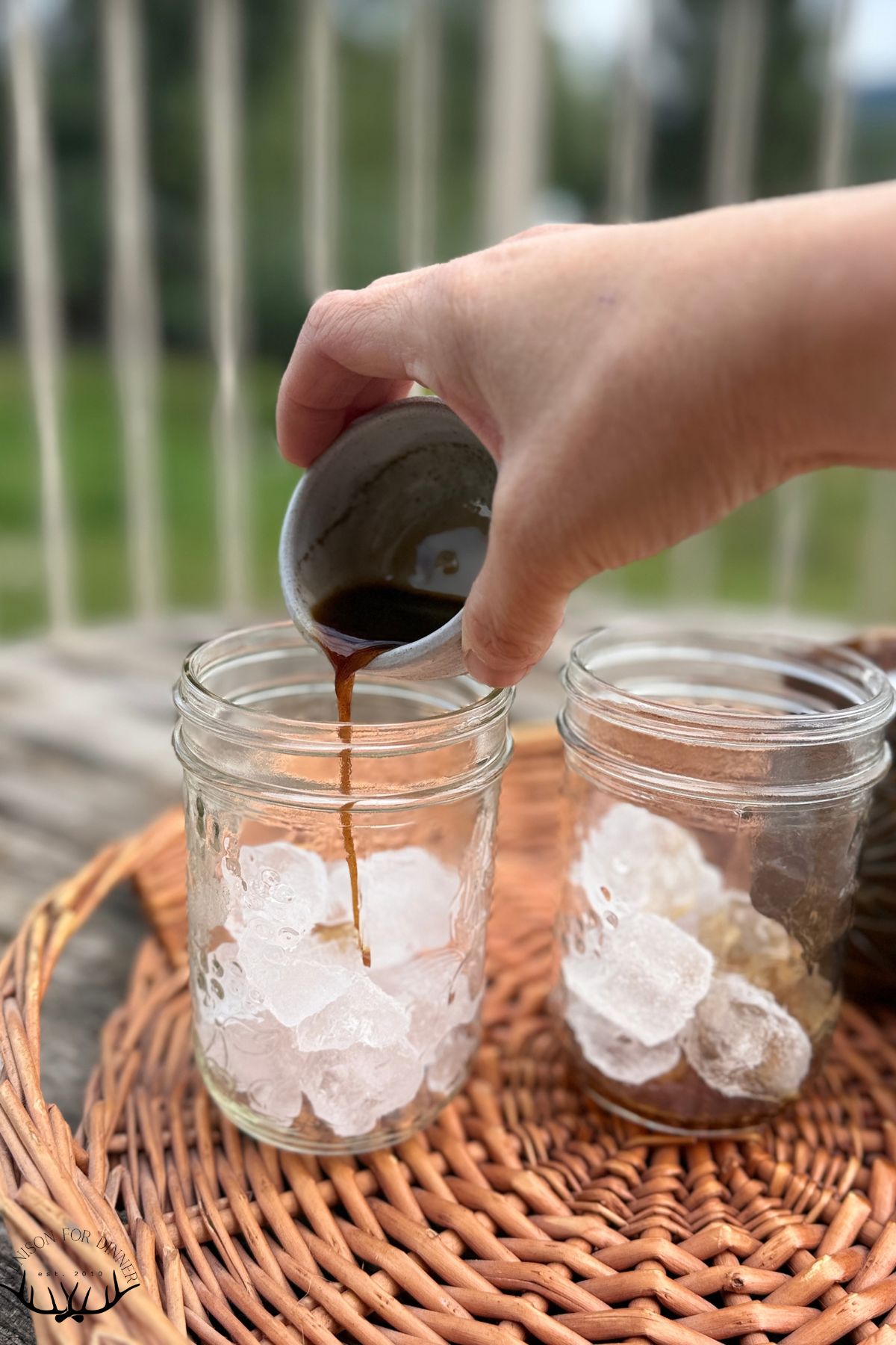Pouring pumpkin syrup over ice.