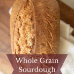Loaf of whole grain sourdough on a cutting board.