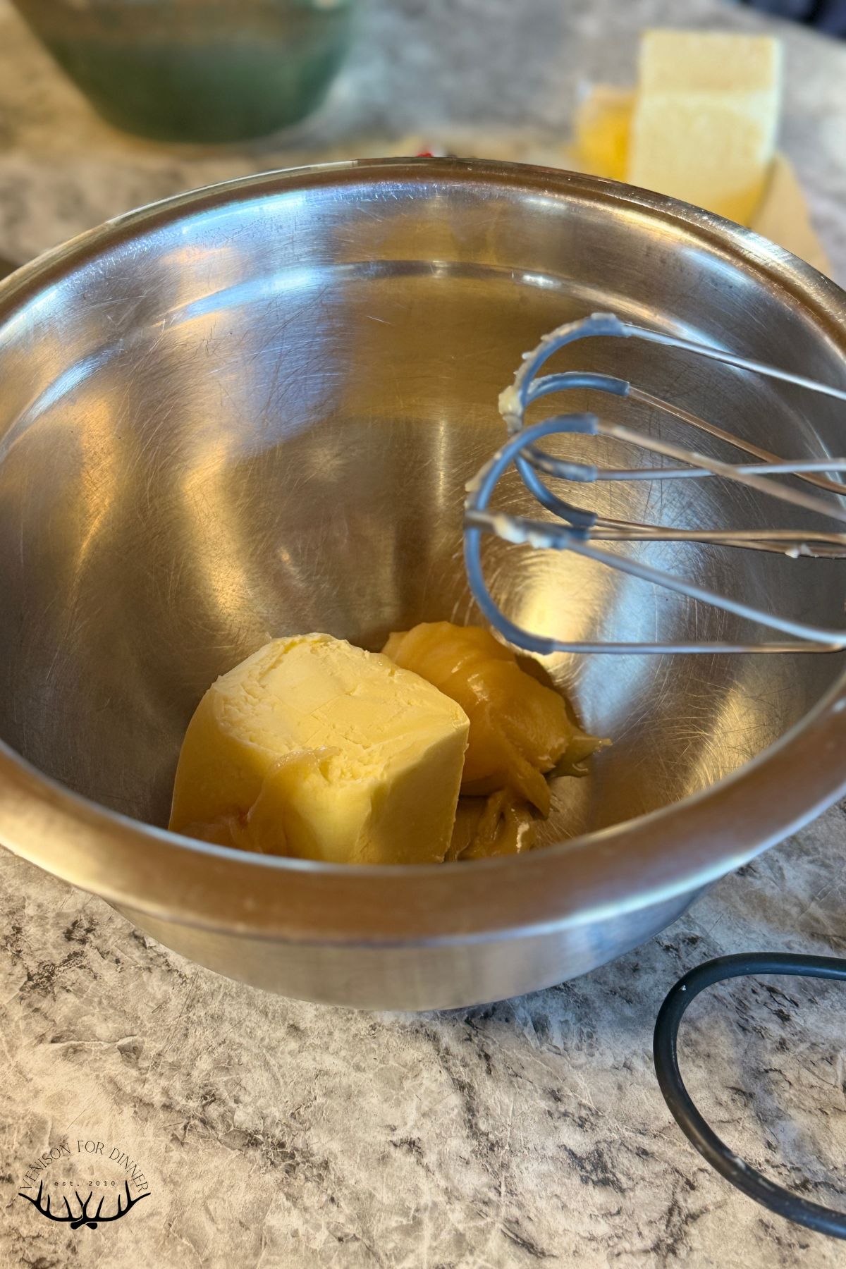 Butter and creamy honey in a mixing bowl.