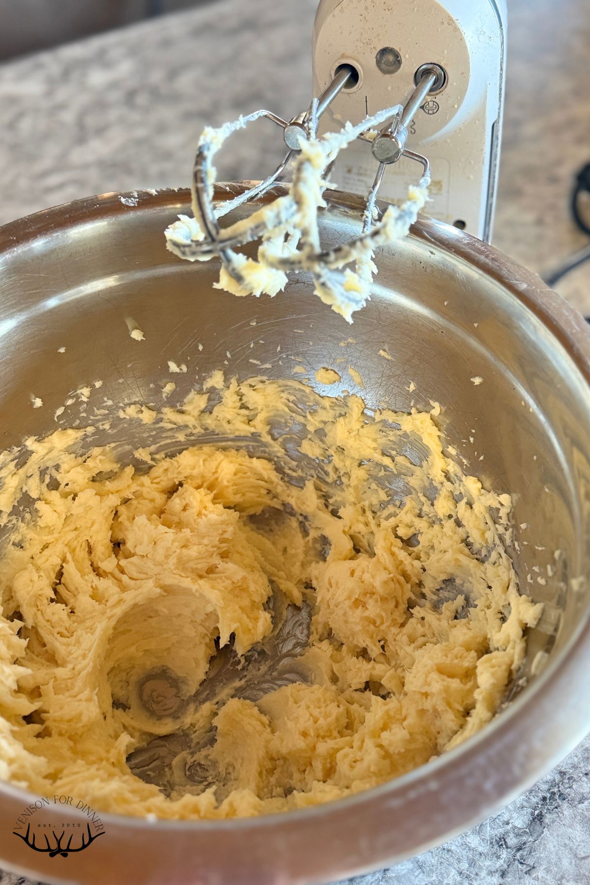 Creamed butter and honey in a bowl.
