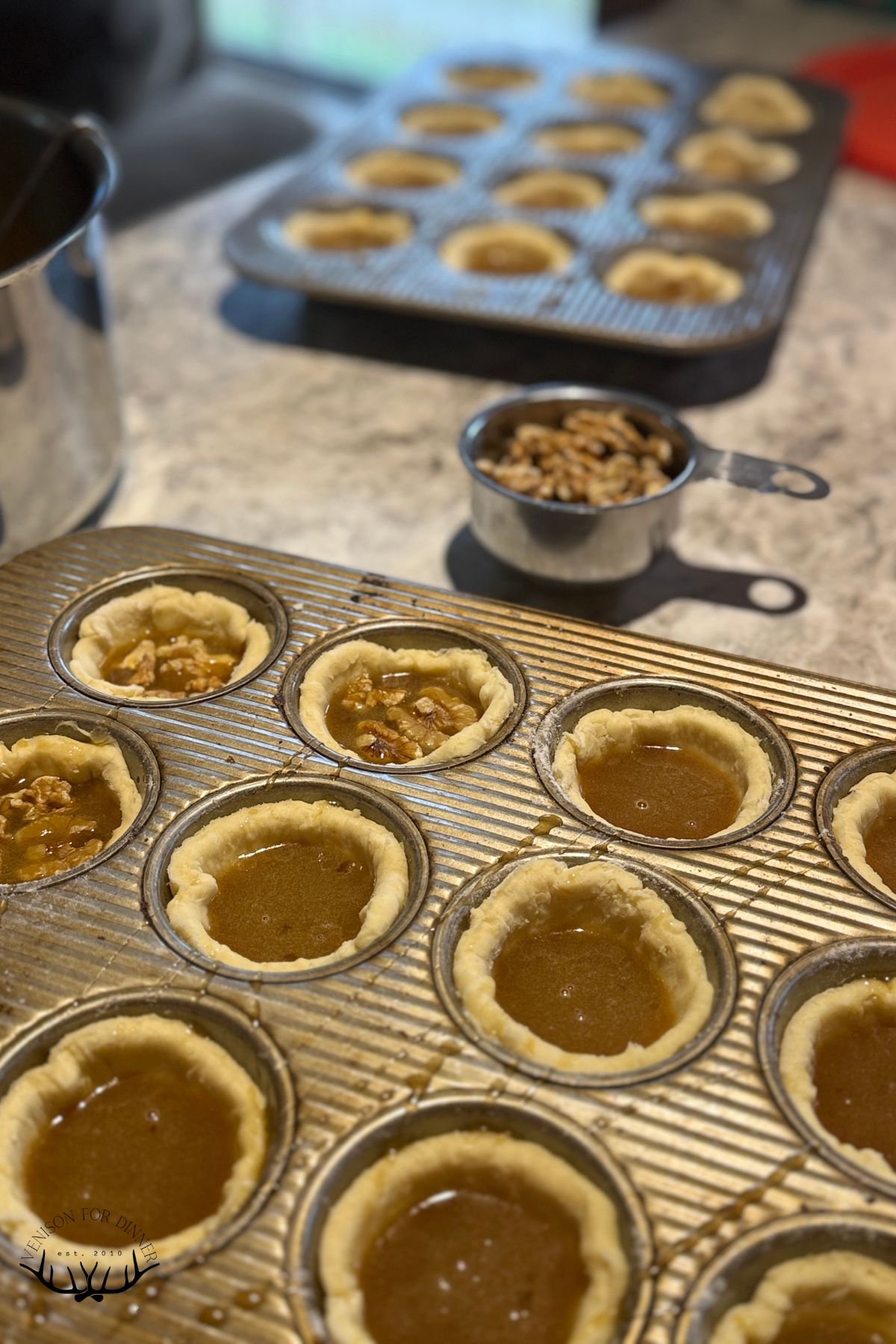 Adding walnuts to butter tarts.