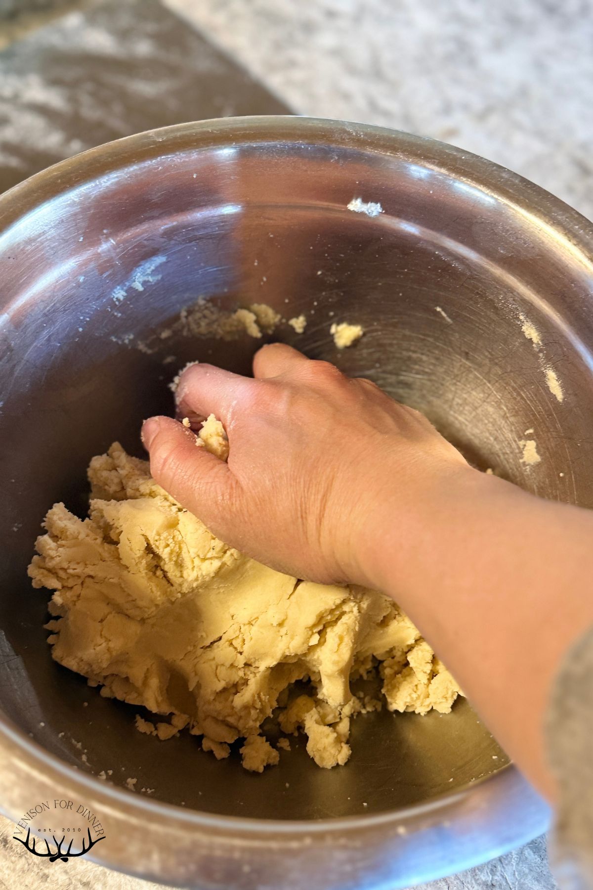 Pressing cookie dough together.