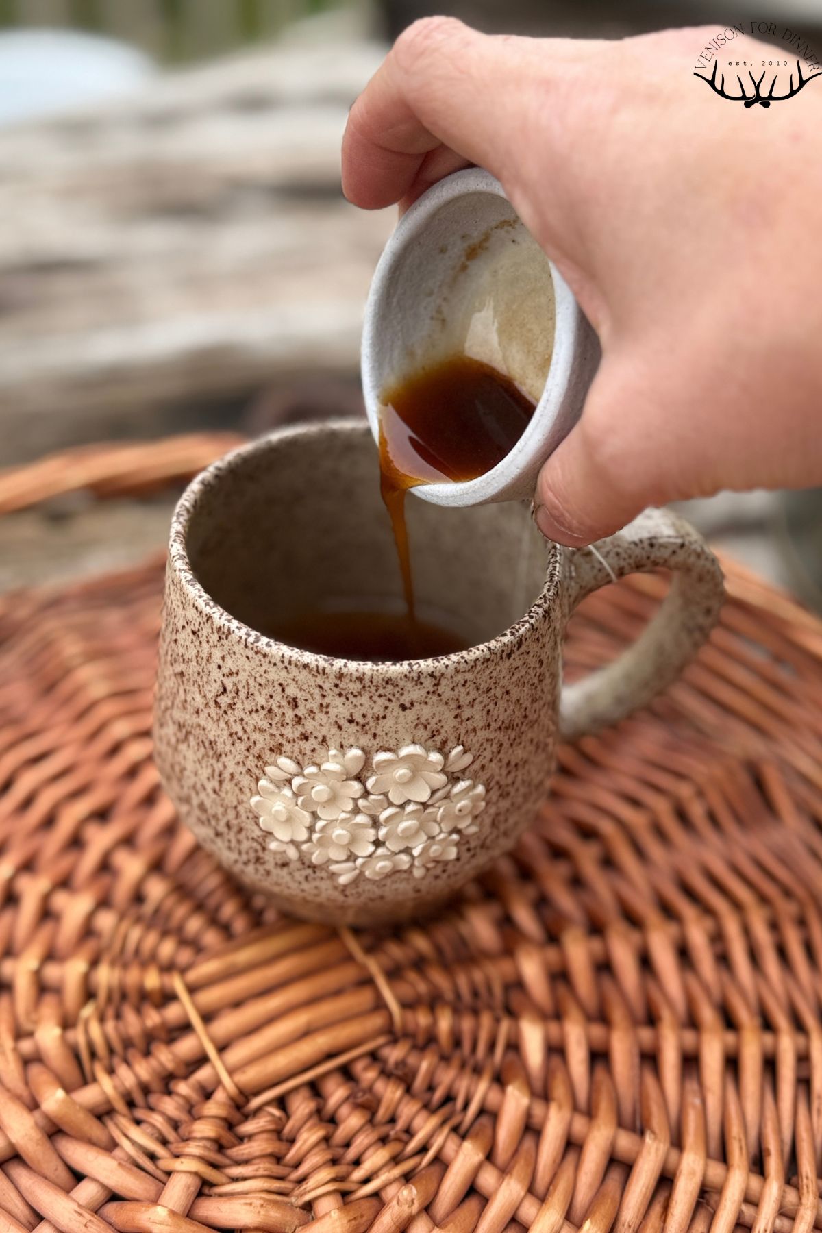 Adding pumpkin syrup to steeped tea.