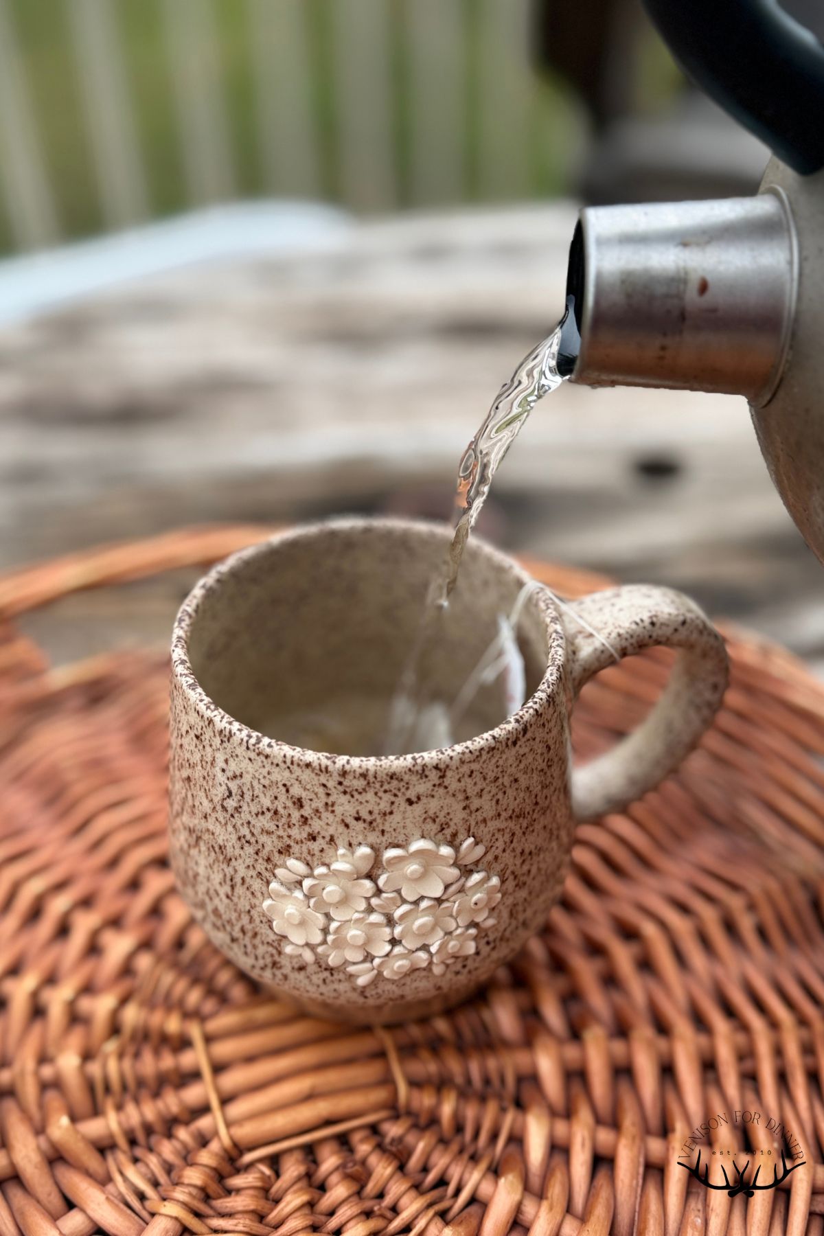 Pouring the kettle into a mug.