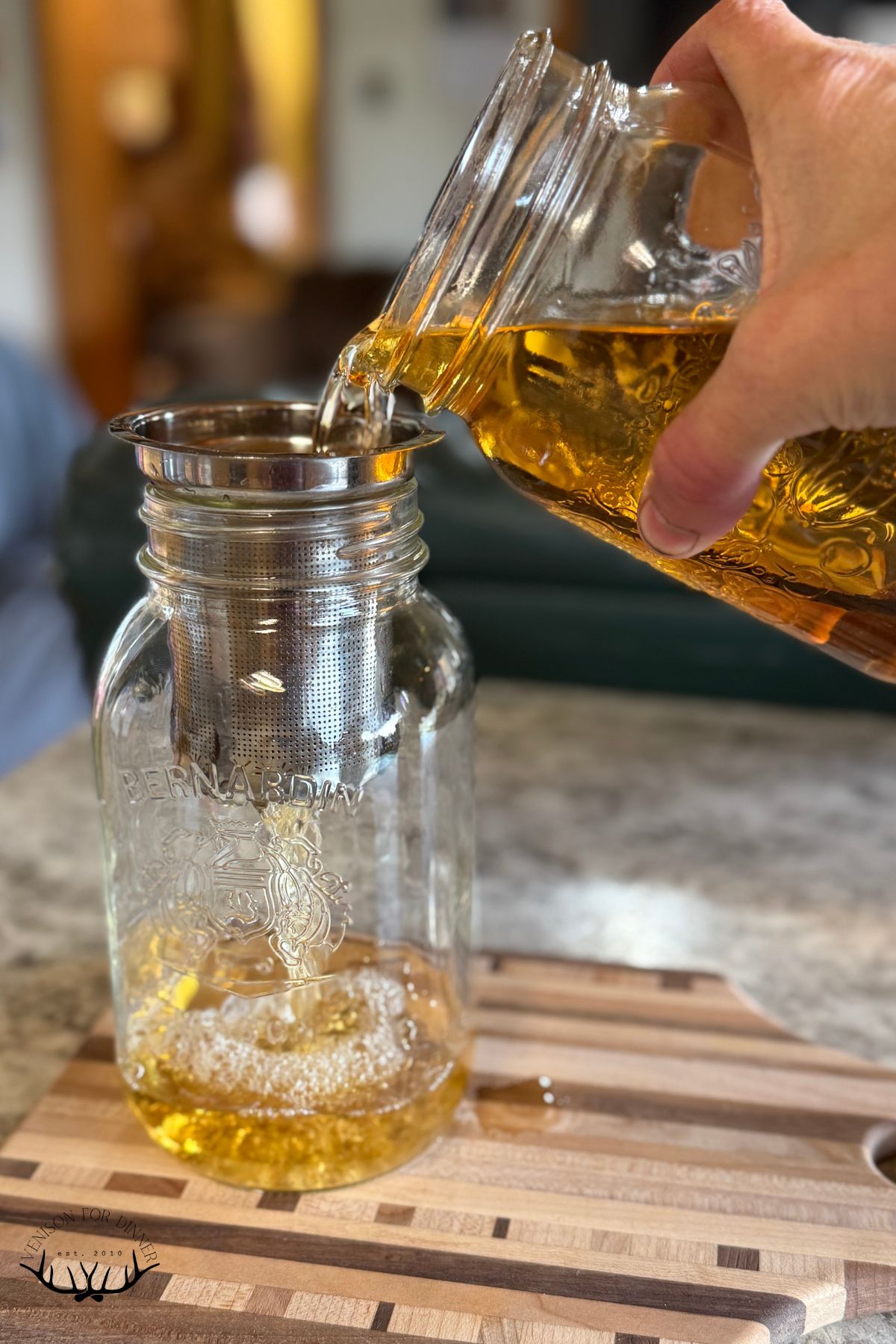 Straining spices out of rum.