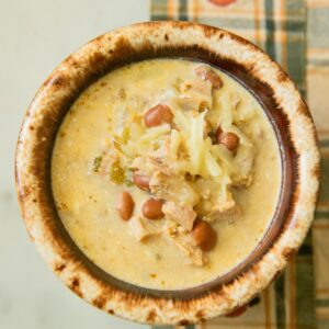 Bowl of turkey and bean chili with cheese.