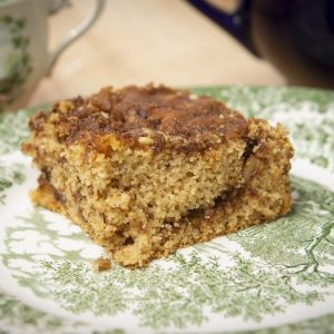 Gluten-free cinnamon crumb coffee cake on a green patterned plate.